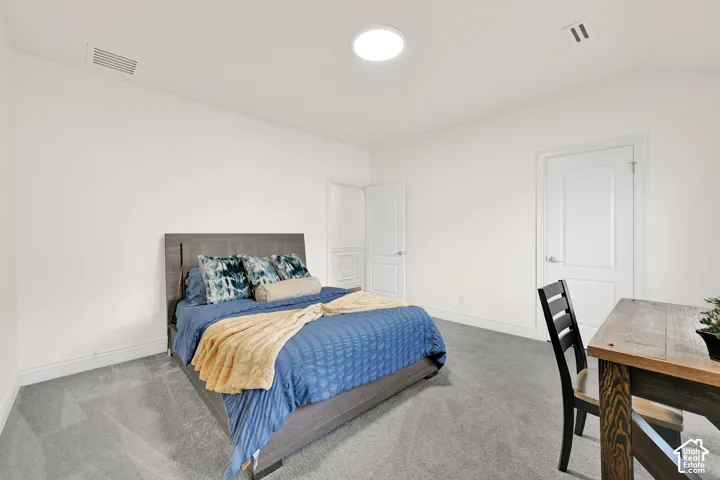 Bedroom featuring carpet flooring and baseboards
