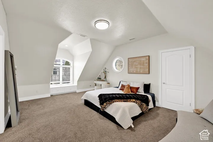 Bedroom featuring carpet flooring and baseboards