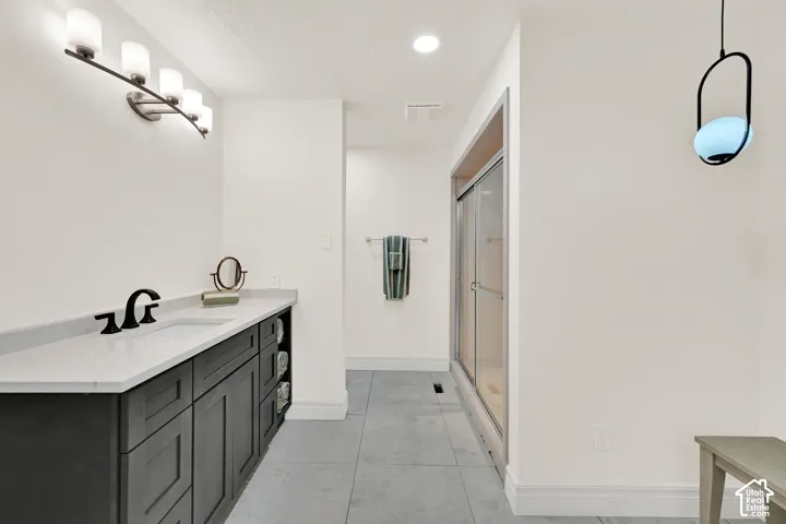 Full bath with vanity, a shower stall, a textured ceiling, and recessed lighting