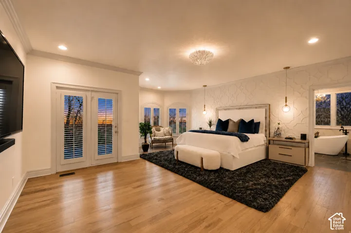 Spacious room featuring wood-finish flooring, recessed lighting, and a textured accent wall