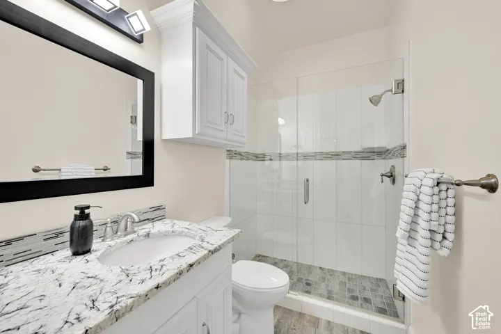 Full bath with vanity and a stall shower