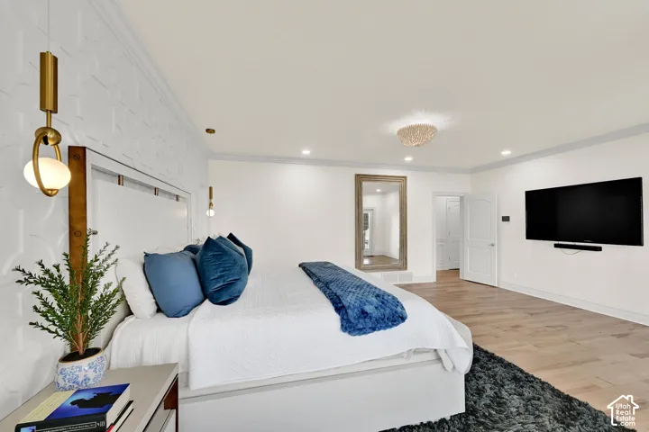 Bedroom featuring crown molding, light wood finished floors, and recessed lighting