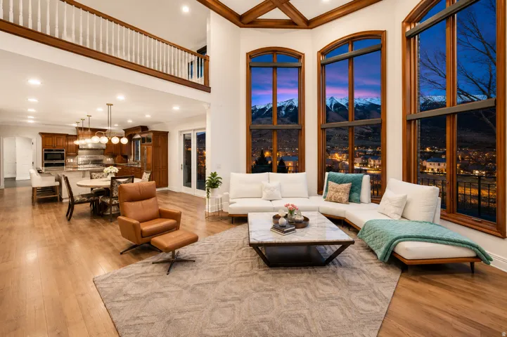 Great room featuring floor-to-ceiling windows with mountain and city views, wood-finish flooring, and a coffered ceiling
