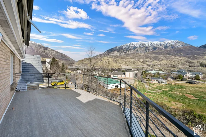 Deck with a mountain view, a patio, and a residential view