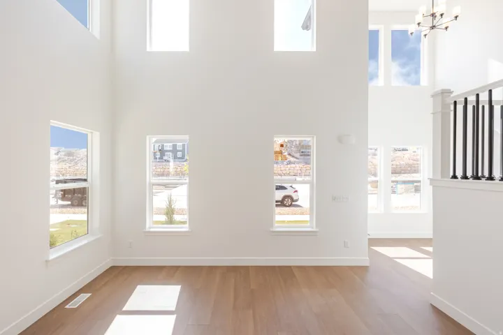Two-story living area featuring tall ceilings and abundant natural light
