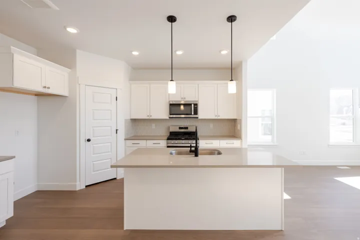 Modern kitchen island with an undermount sink and matte black faucet