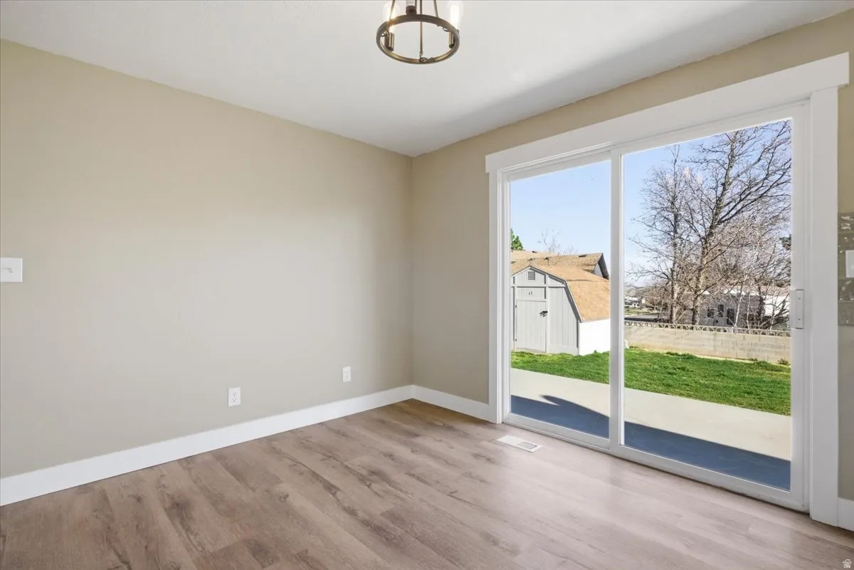 Empty room with baseboards and light wood-style floors