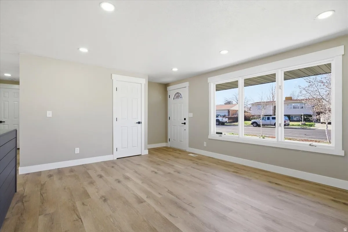 Unfurnished living room featuring light wood-style floors and recessed lighting