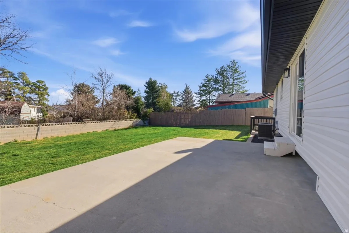 Fenced backyard featuring a patio