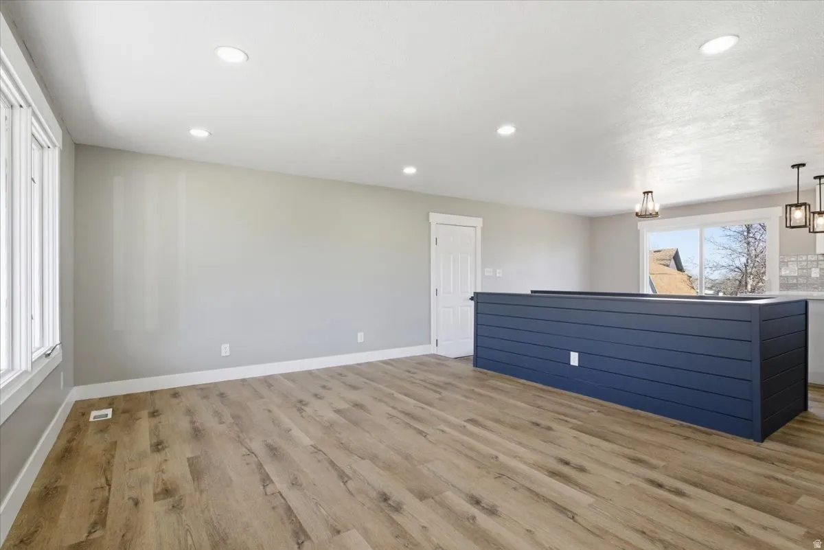 Unfurnished living room featuring light wood-style flooring and recessed lighting