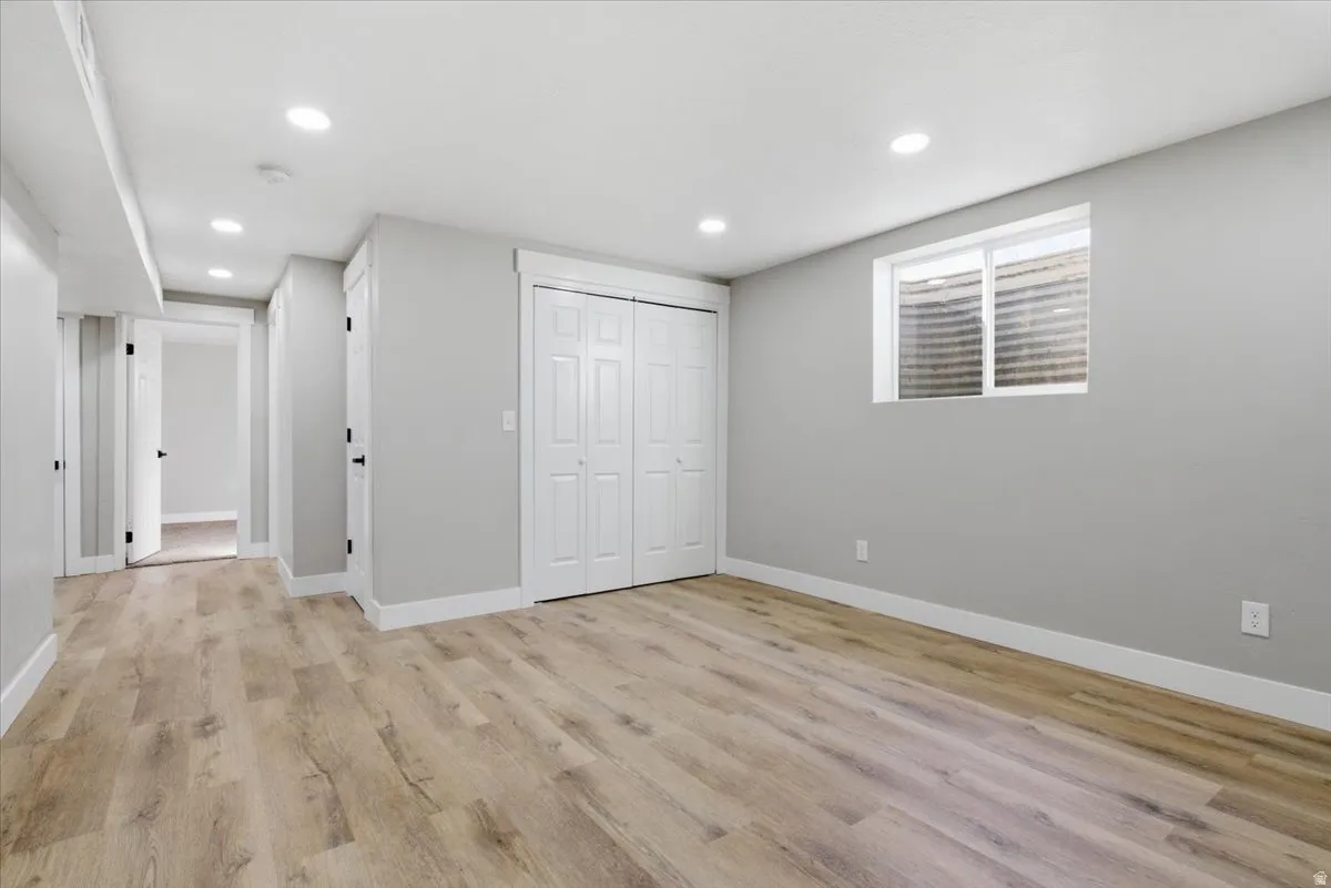 Unfurnished bedroom featuring a closet, light wood finished floors, and recessed lighting