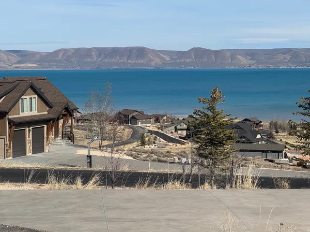 Water view with a mountainous background and nearby suburban area