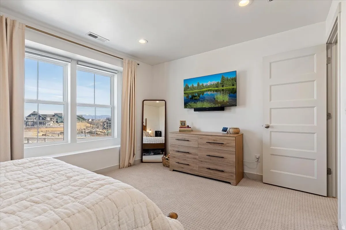 Bedroom featuring light carpet and recessed lighting