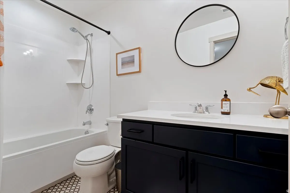 Full bath featuring vanity and shower / washtub combination