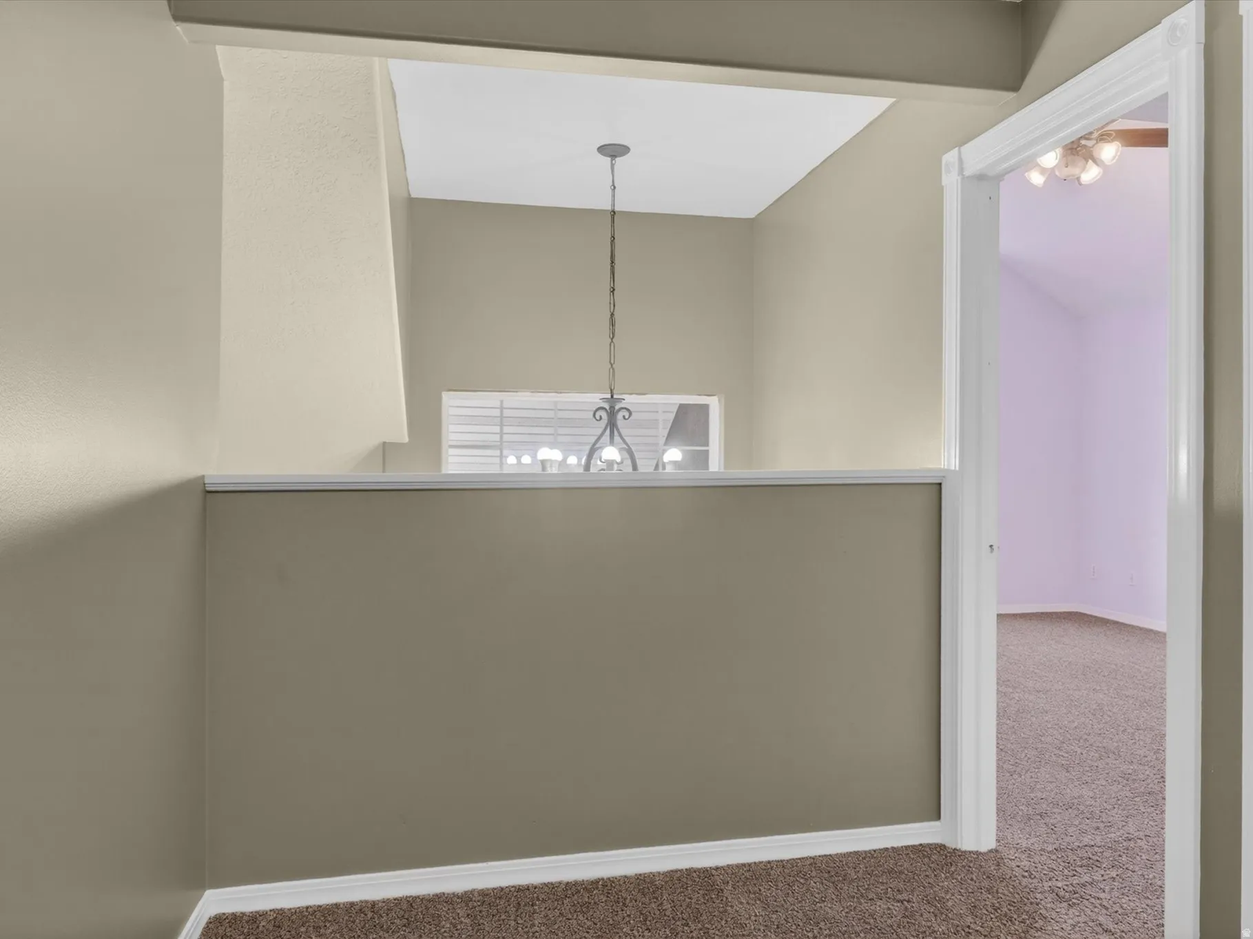 Hall featuring carpet flooring and baseboards