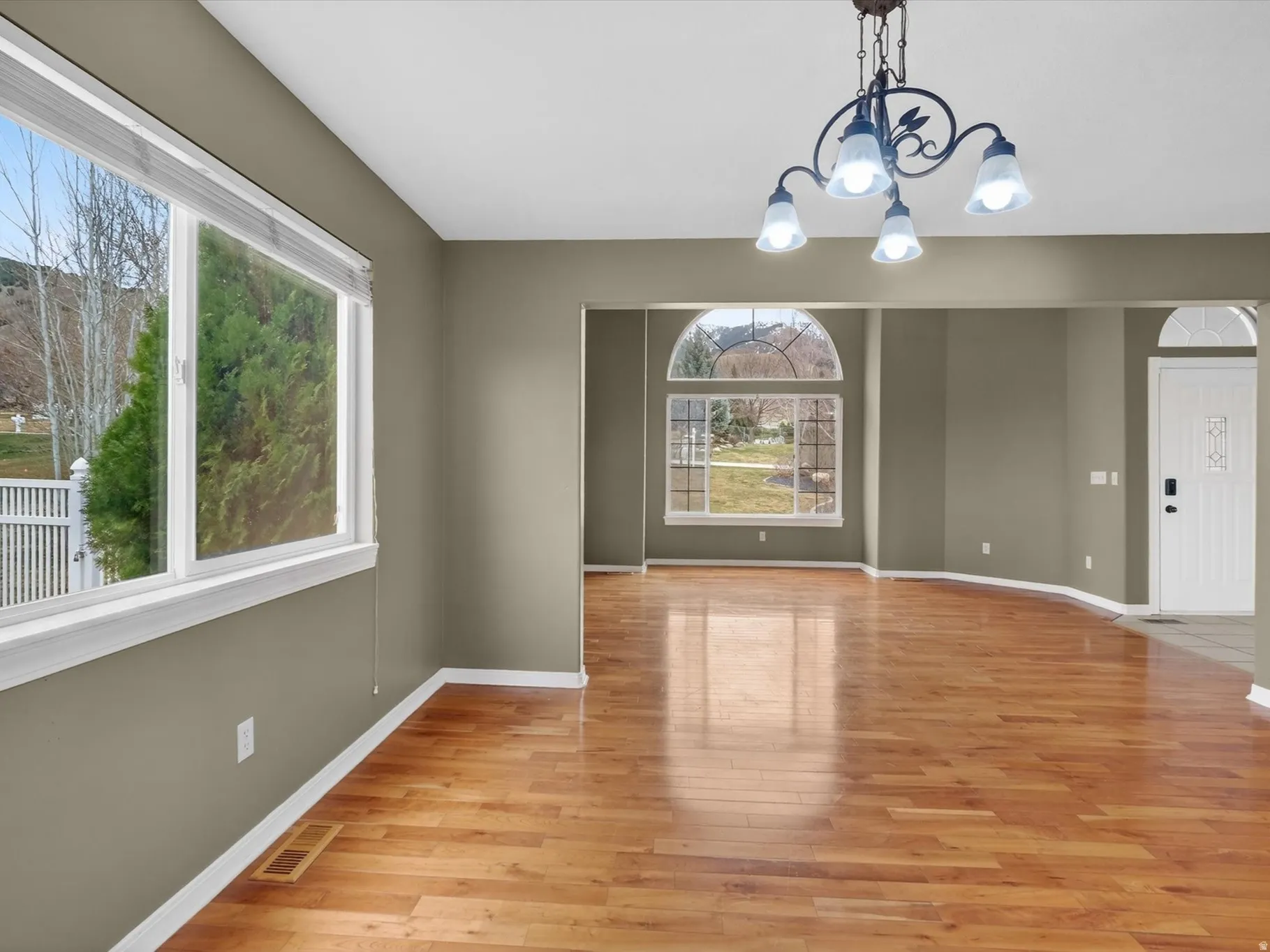 Unfurnished dining area featuring a chandelier and light wood finished floors