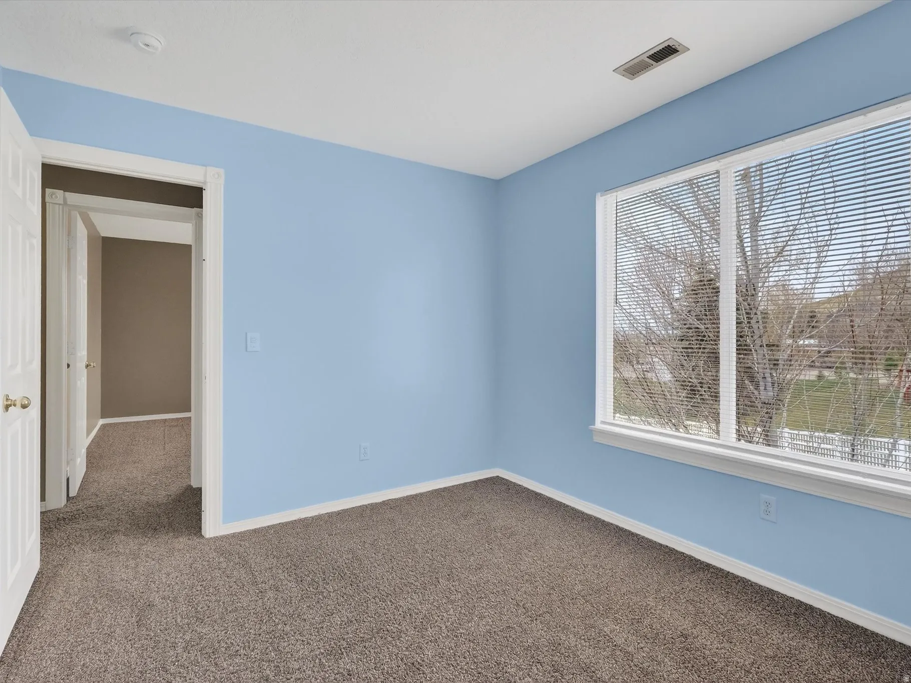 Unfurnished room with dark colored carpet