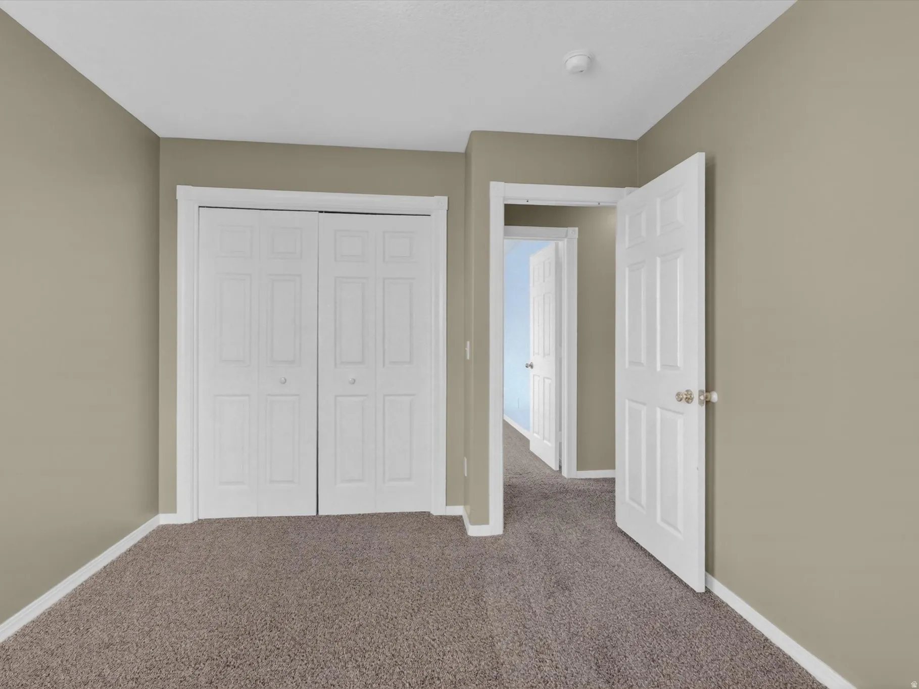 Unfurnished bedroom with carpet flooring and a closet