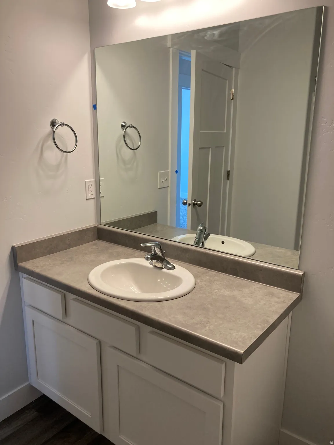 Bathroom with vanity and dark wood-style flooring