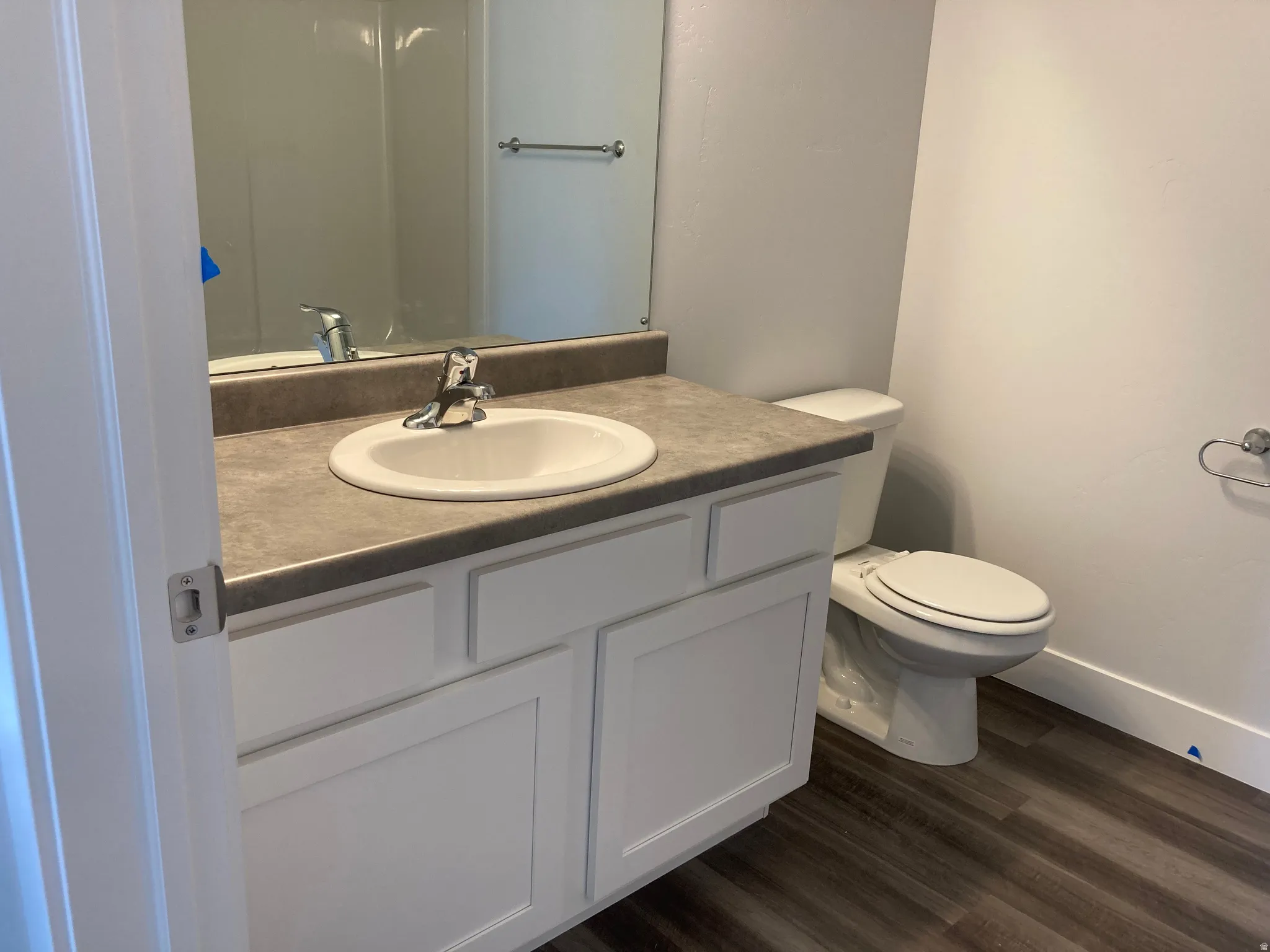 Bathroom featuring vanity and dark wood-style flooring