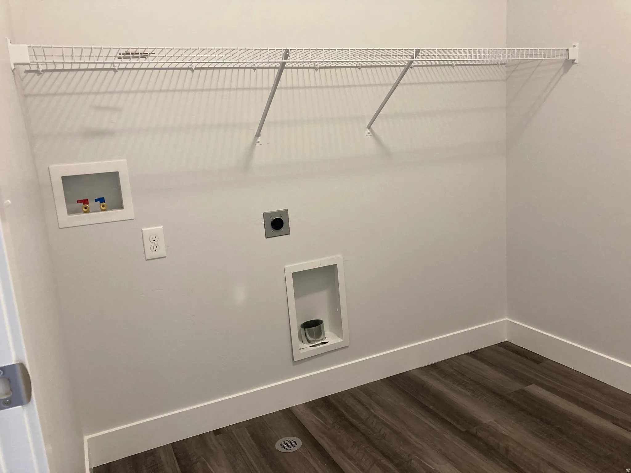Laundry area featuring hookup for a washing machine, dark wood-style flooring, and hookup for an electric dryer