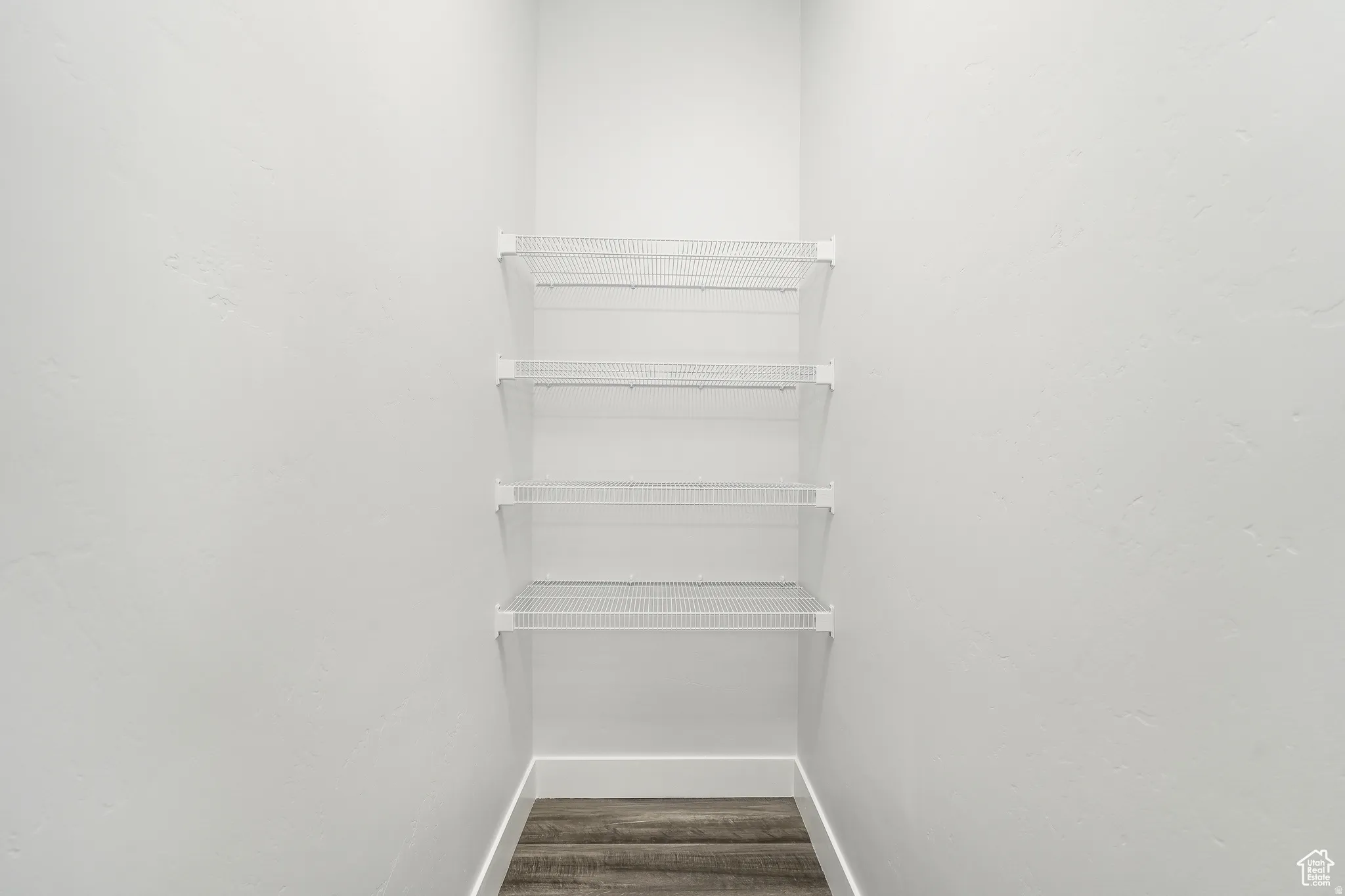 Walk in closet featuring dark wood finished floors