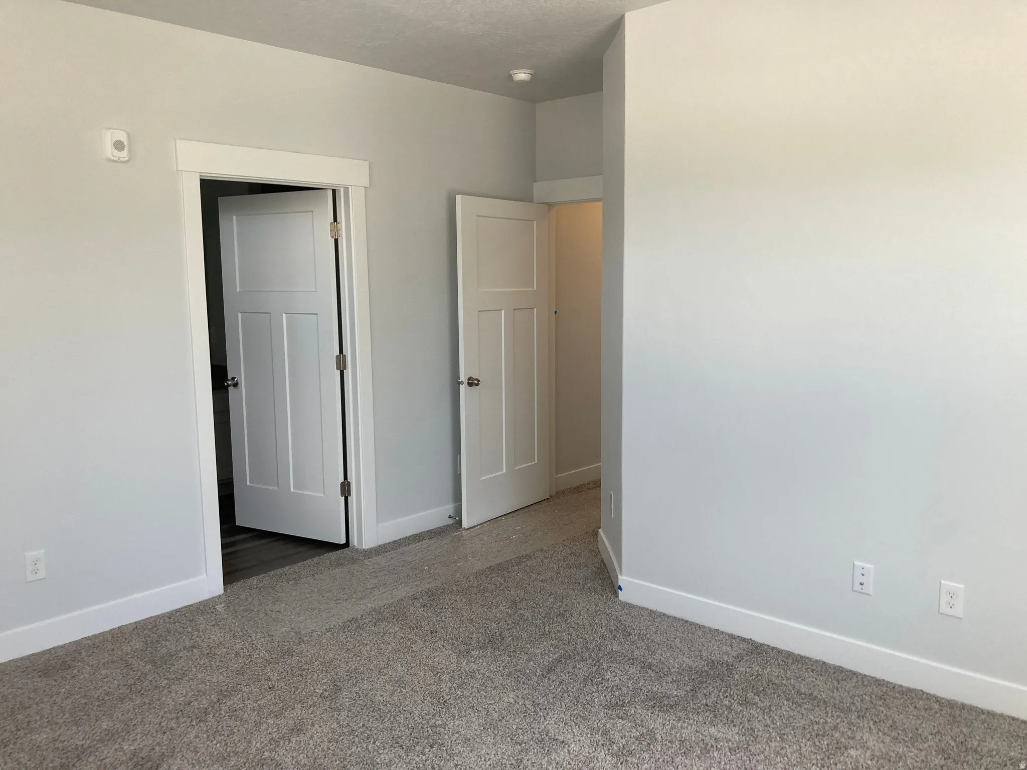 Unfurnished bedroom with baseboards and carpet flooring
