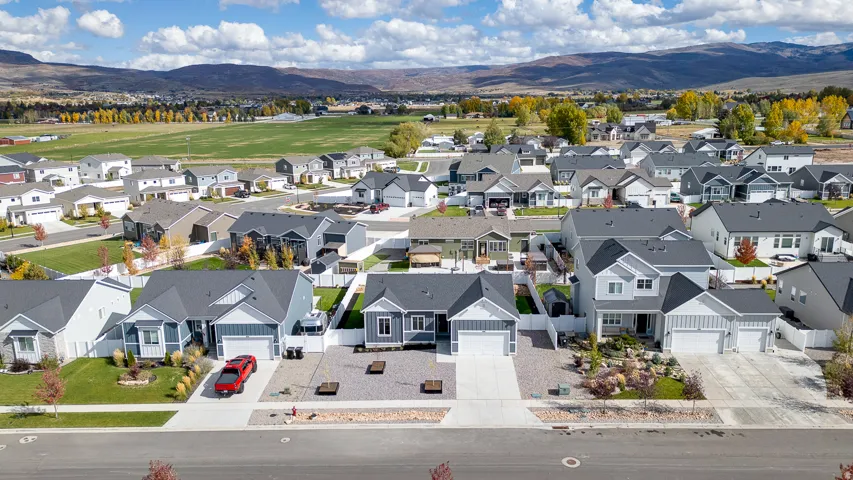 Aerial perspective of suburban area featuring a mountainous background