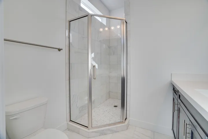Full bathroom featuring vanity and a stall shower