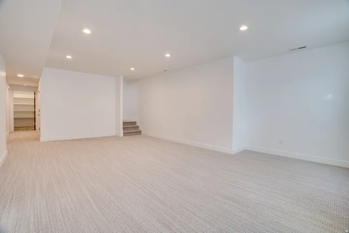 Spare room with recessed lighting and light carpet