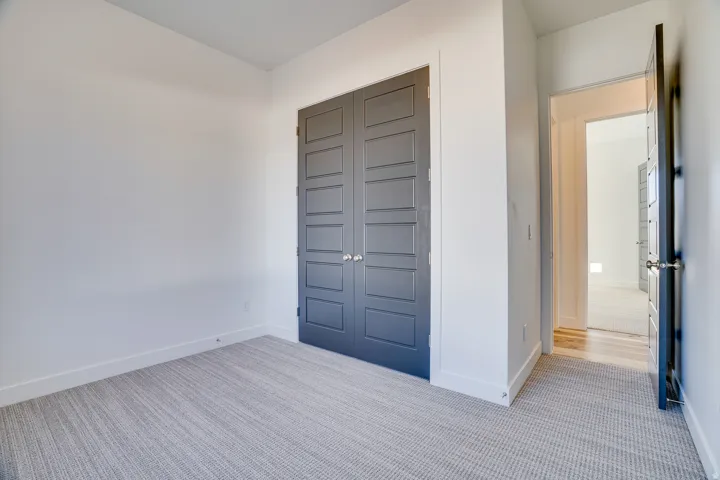 Foyer with light colored carpet and baseboards