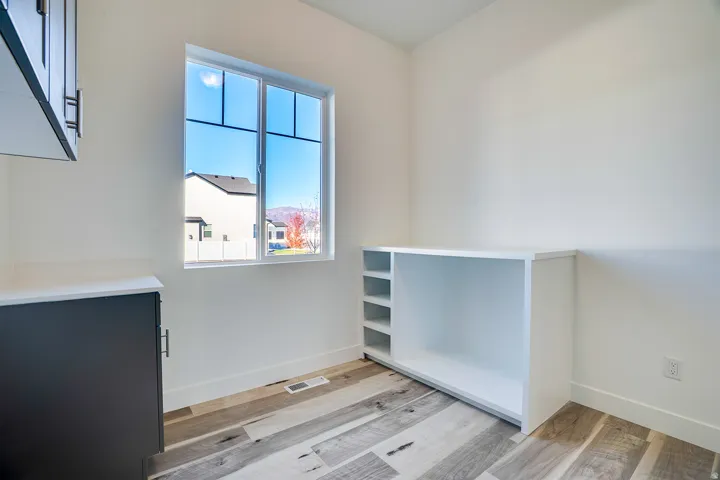 Empty room with light wood-style flooring and baseboards