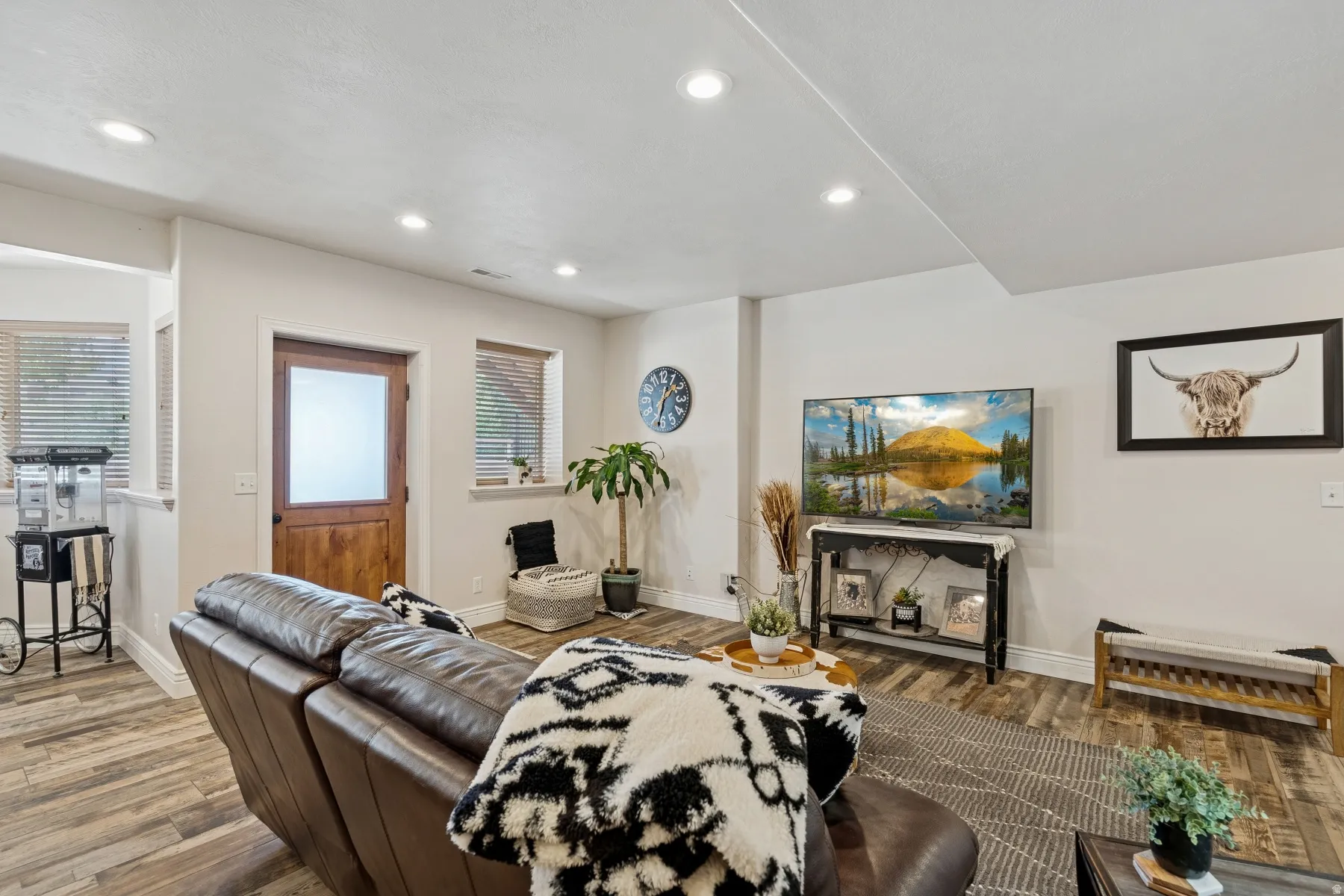 Living room featuring wood finished floors, plenty of natural light, and recessed lighting