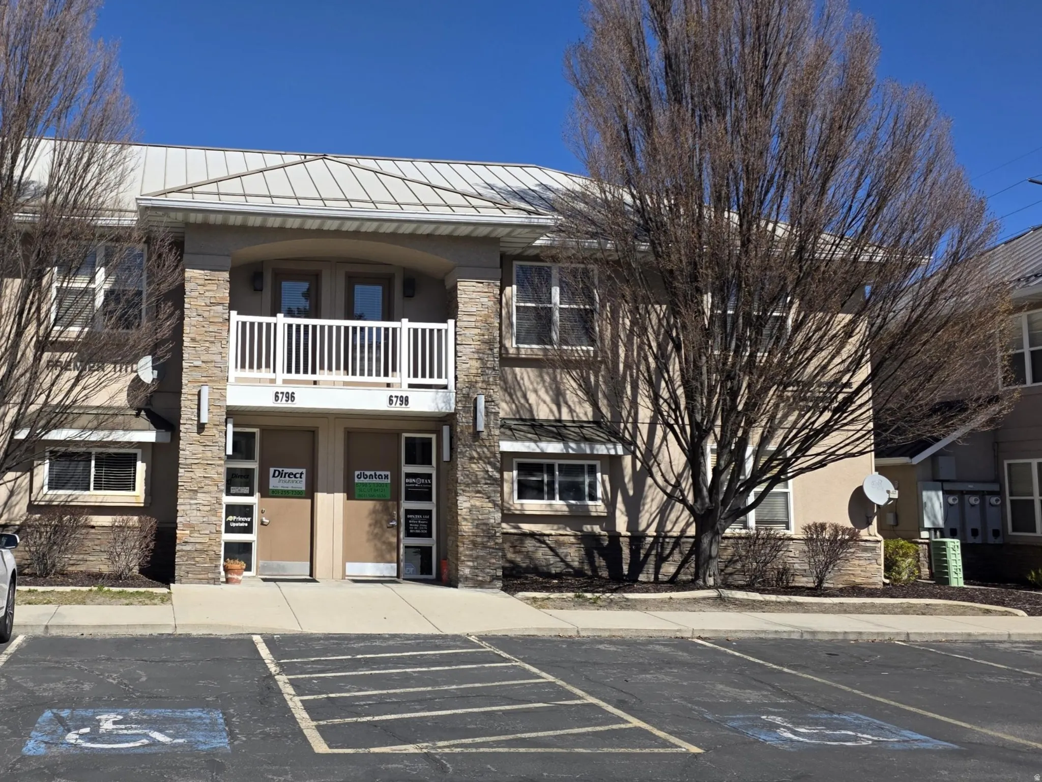 View of apartment building / complex with uncovered parking