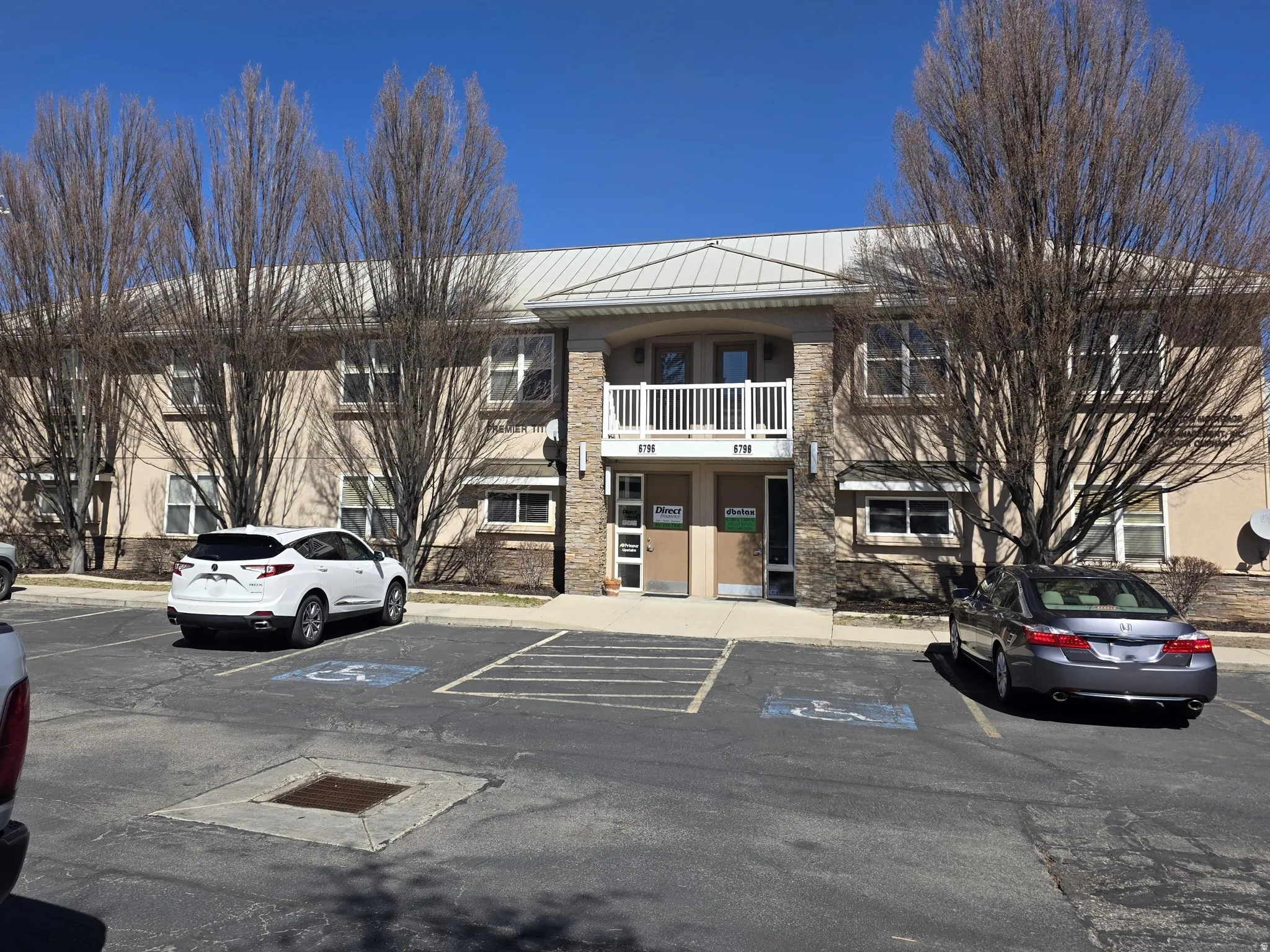 View of property featuring uncovered parking