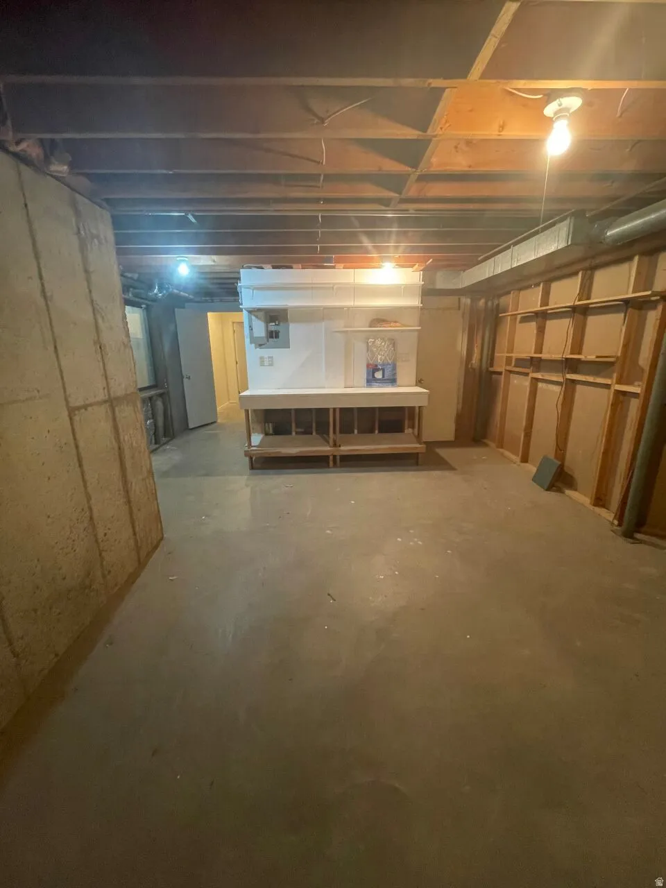 View of unfinished below grade area with work bench