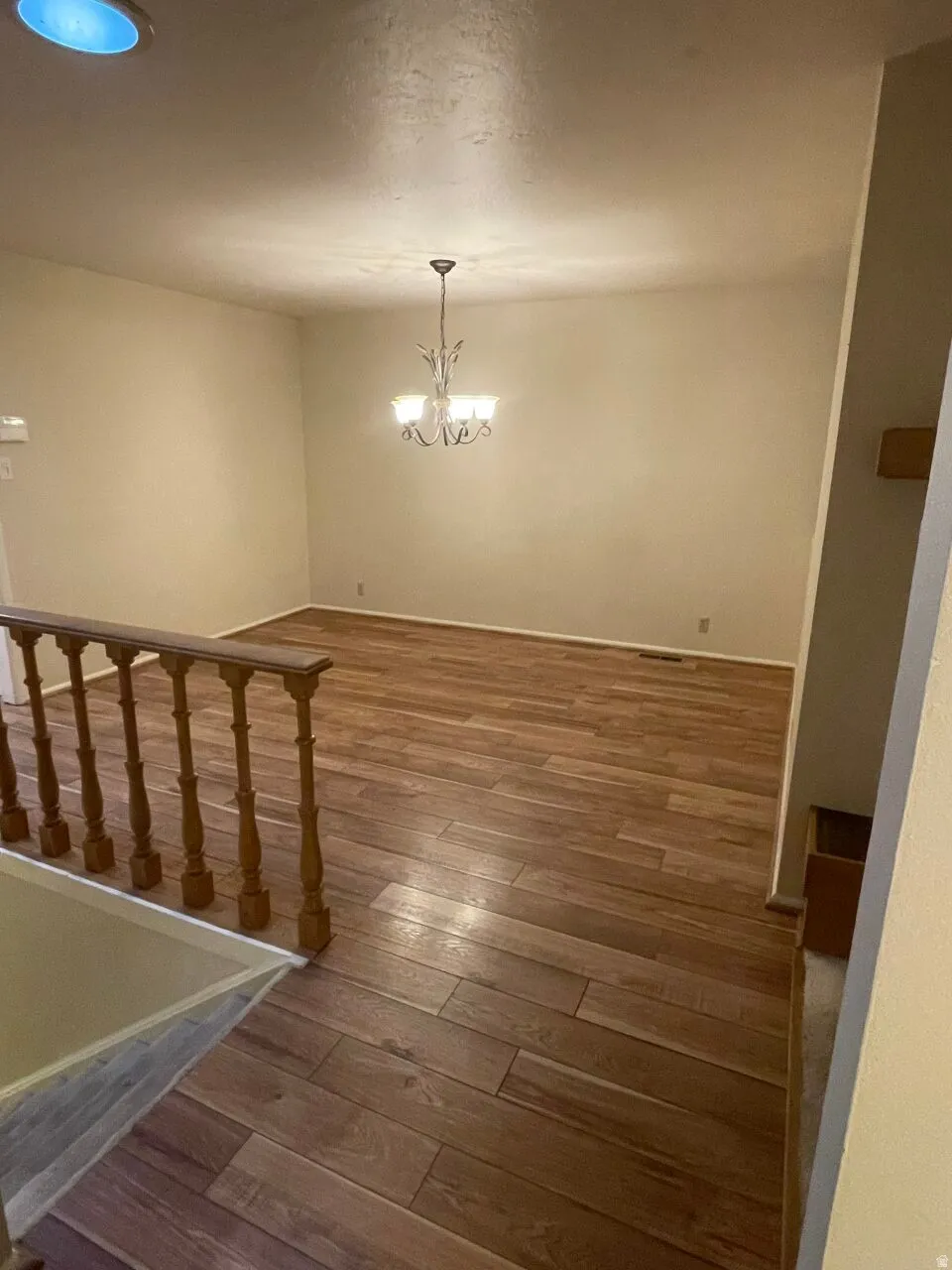 Dining area near stairs featuring hardwood / wood-style flooring and hanging lights
