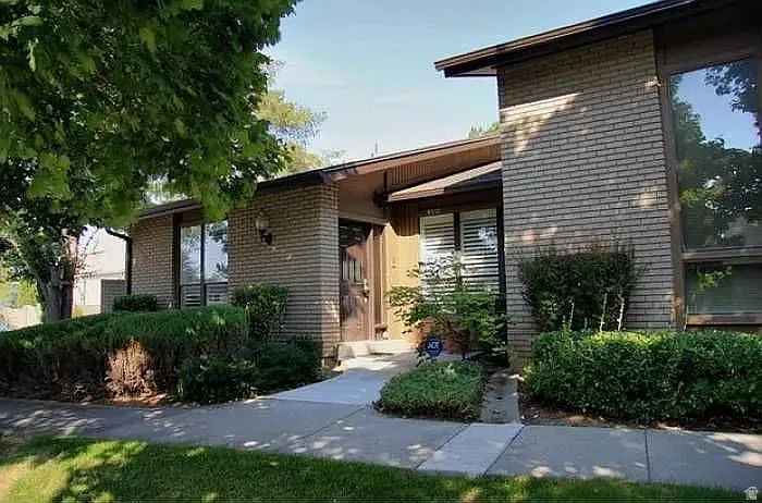 Entrance to property featuring brick siding