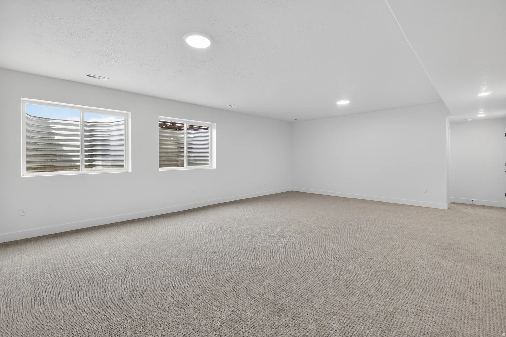 Empty room with carpet and baseboards