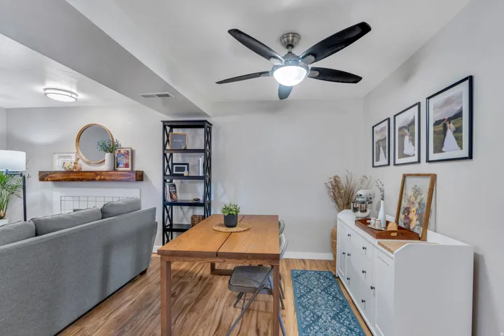 Dining room with wood finished floors and a ceiling fan