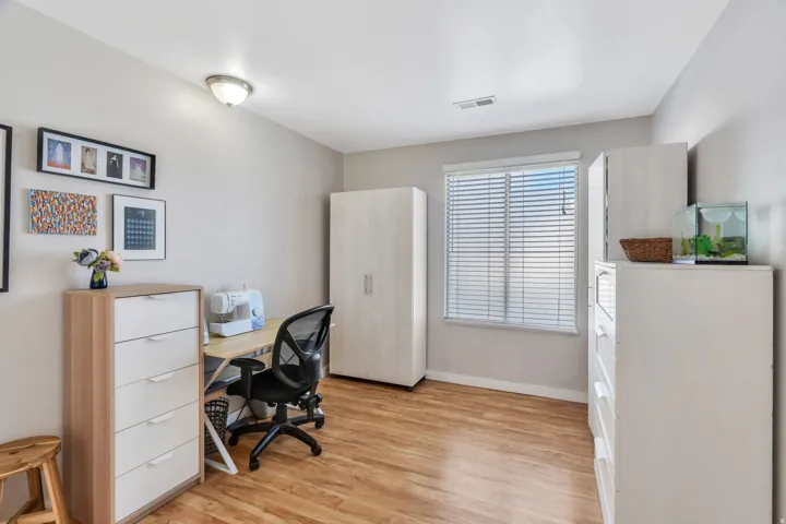 Home office with light wood-style floors and baseboards