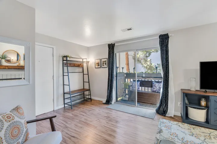 Living area with light wood-style floors and baseboards