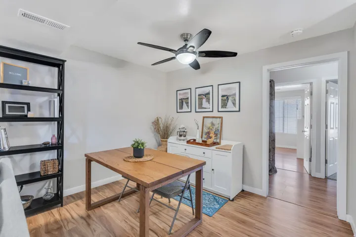 Office space with light wood-type flooring and a ceiling fan