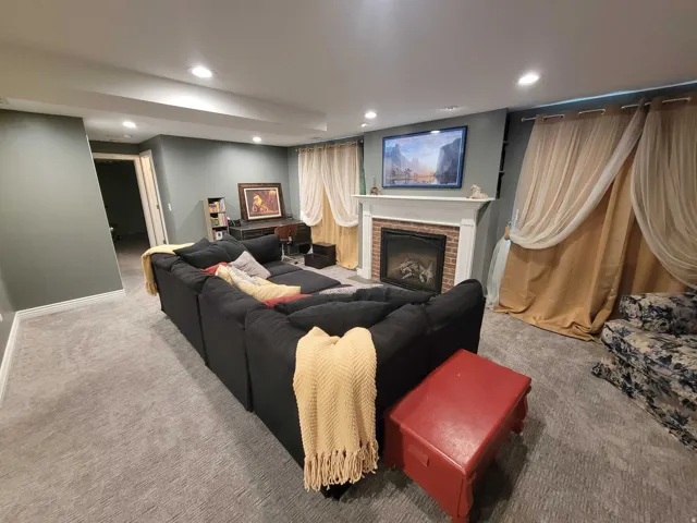 Living room featuring recessed lighting and a fireplace