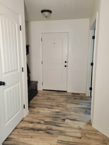 Corridor featuring light wood-style floors