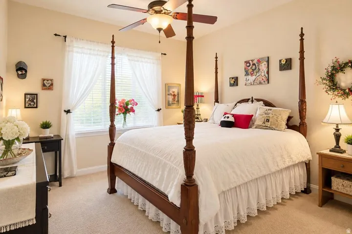 Carpeted flooring, ceiling fan with integrated lighting, window with blinds, and neutral wall tones