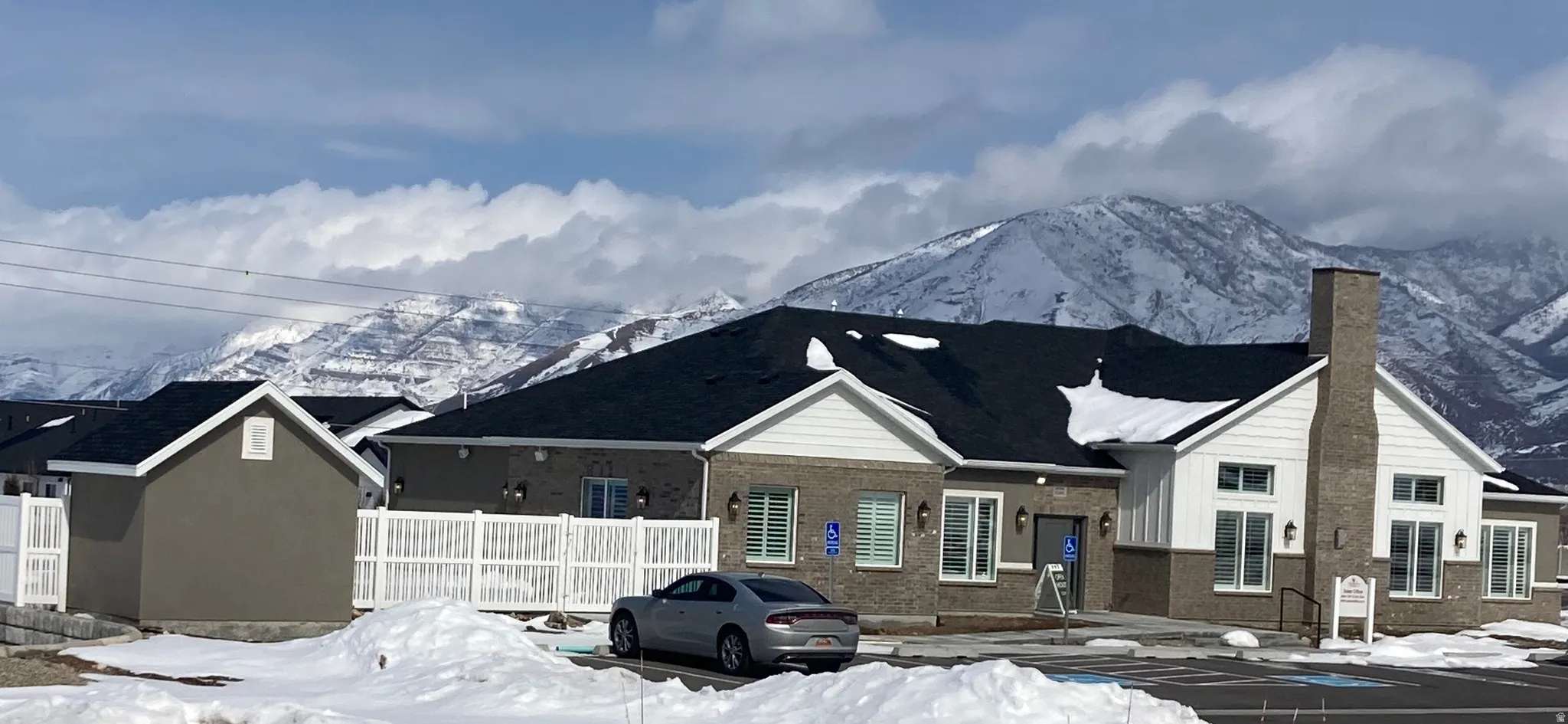 CLUBHOUSE featuring a mountain view, a chimney, and brick siding