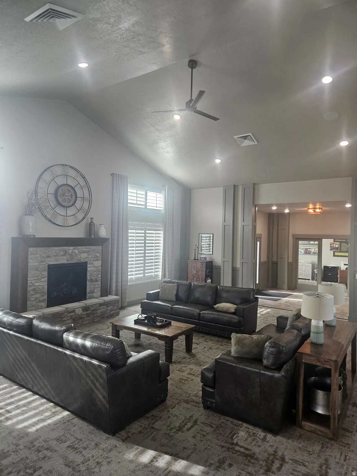 CLUBHOUSE Living area featuring a ceiling fan, a stone fireplace, recessed lighting, and carpet