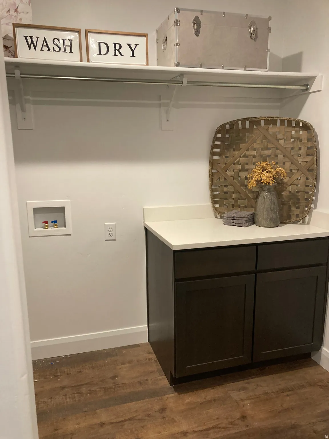 MODEL Laundry room featuring dark wood finished floors and hookup for a washing machine