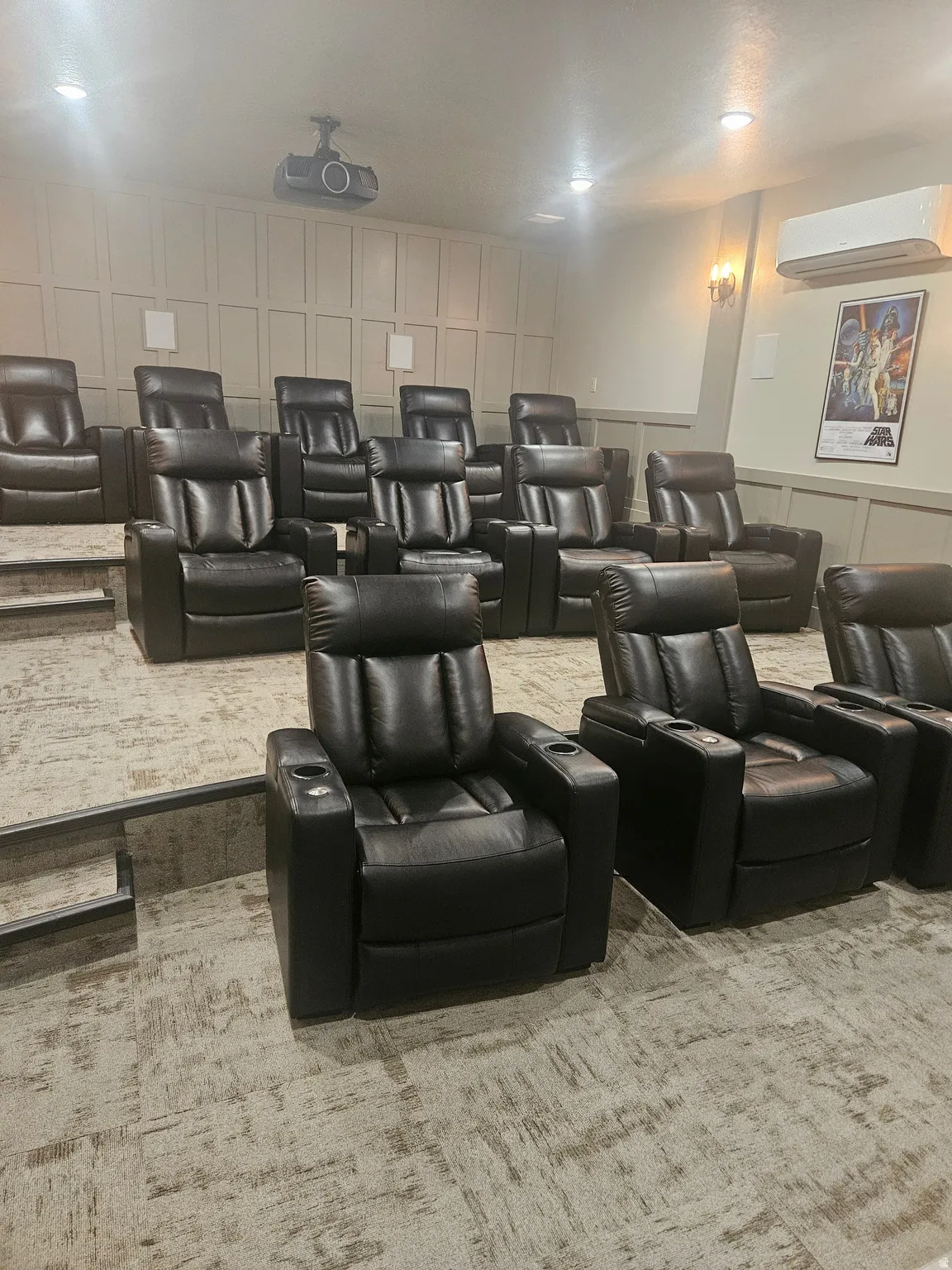 CLUBHOUSE Cinema room featuring a decorative wall, light colored carpet, and a mini split for heating / cooling
